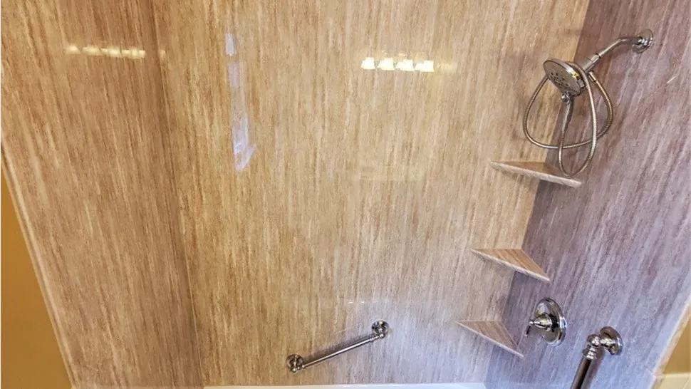 A bathroom with a shower and tiled walls.